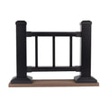 Black metal gate with wooden base on a white background