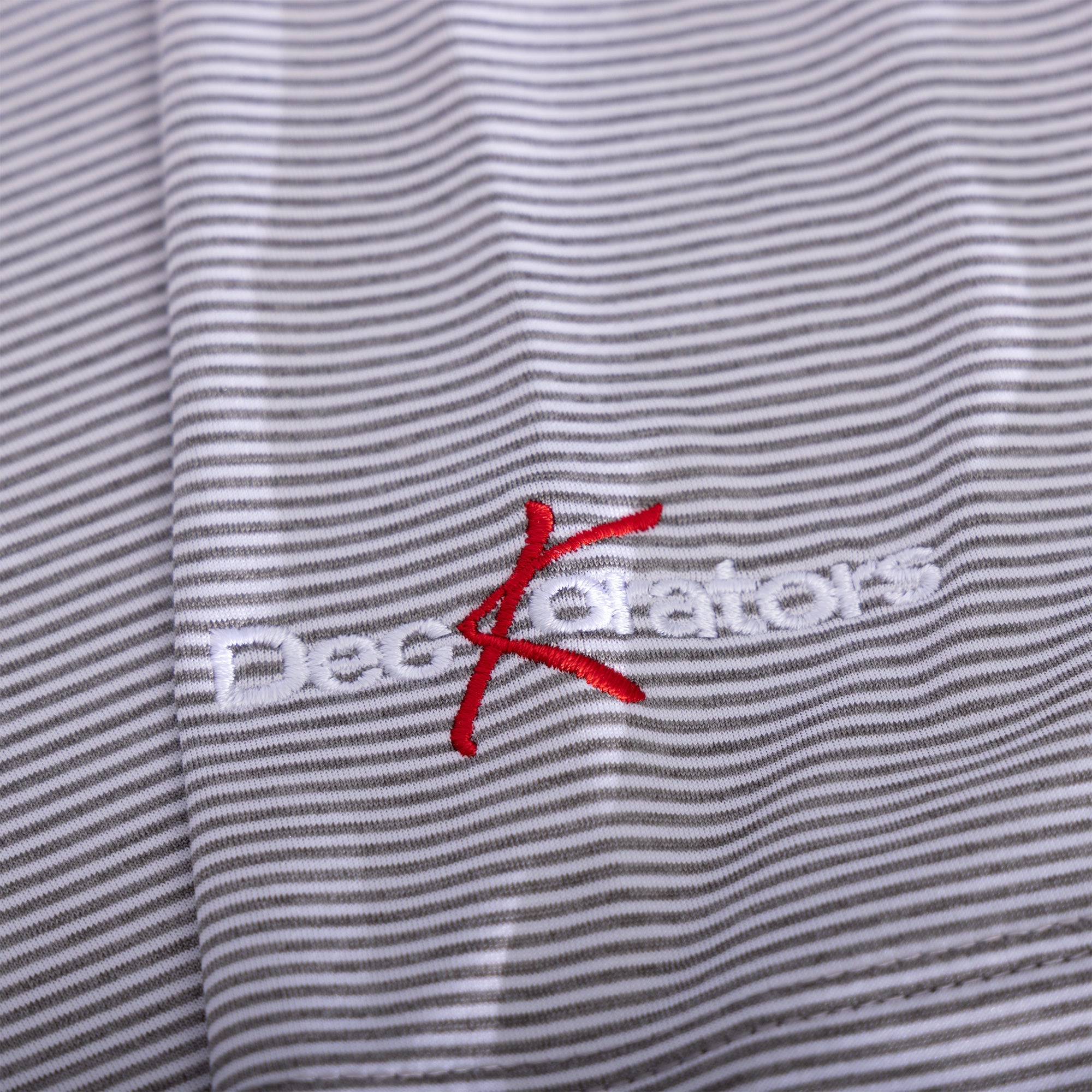 Close-up of Deckorators logo on sleeve of Johnnie-O Men's Meteor Lyndon Striped Polo