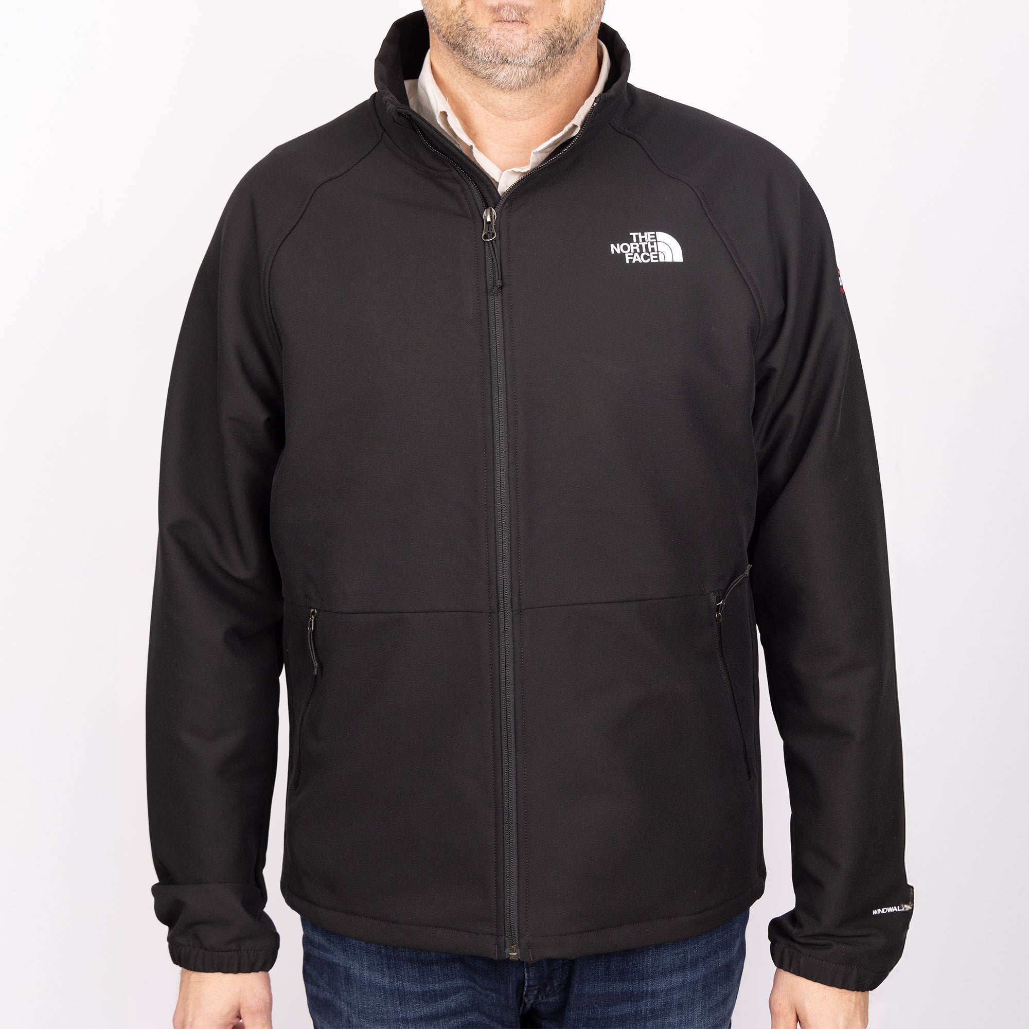 Person wearing Men’s The North Face® Soft Shell Jacket in Black with the Deckorators logo embroidered on the sleeve