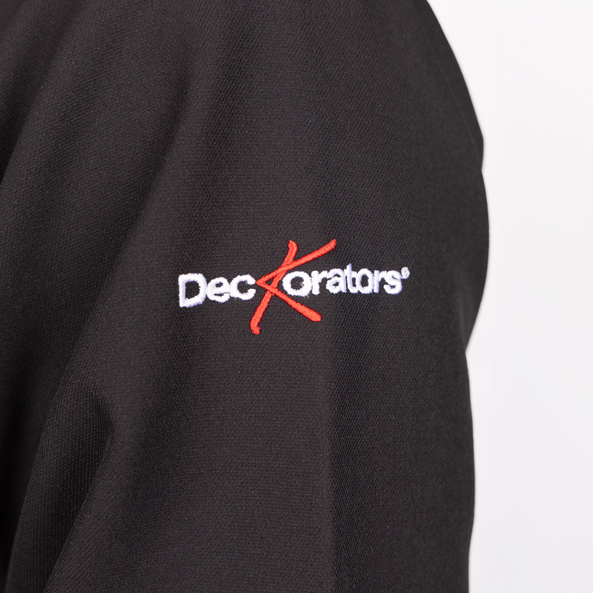 Close-up of Deckorators logo embroidered on the sleeve of The Men's North Face® Soft Shell Jacket in Black