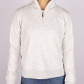 Women's TravisMathew Cloud Fleece quarter-zip sweatshirt worn by a person on a light gray background